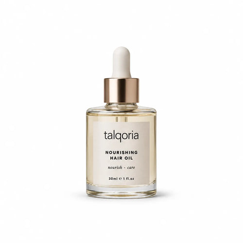 A bottle of talqoria Nourishing Hair Oil with a clear glass body, pale beige oil inside, a metallic gold collar, and a white dropper cap, centered on a white background.