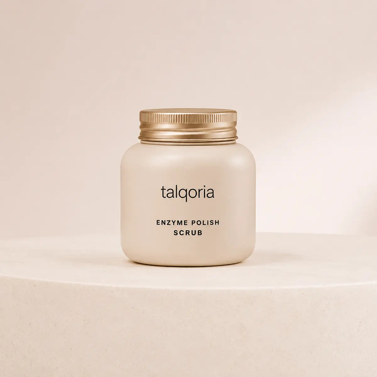 A frosted cream-colored jar of talqoria Enzyme Polish Scrub with a metallic gold screw cap, displayed on a matching cream-colored pedestal against a neutral beige background.